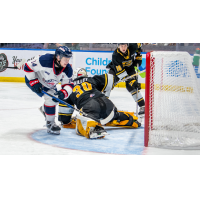 Saginaw Spirit's Joey Willis battles Sarnia Sting's Evan Maillet and James Barr