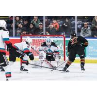 Kelowna Rockets' Marek Rocak and Jake Pilon battle Vancouver Giants' Adam Titlbach